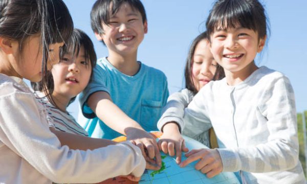 Elementary school students with globe